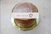 Collect the cake. Coat it on all sides with a thin...