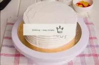 Using a shaped spatula, trim the side of the cake....