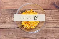 Carefully open the jar with canned corn, drain the...