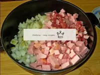 Pour the chopped onions and sausage into a pan wit...
