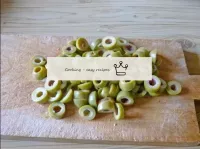 Cut the green olives into rings - cut each olive a...