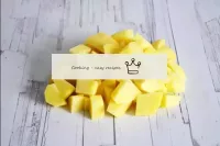 Wash the potatoes, peel and cut into a medium cube...