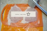 Cover the meat pieces with cling film and beat a l...