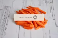 Pulite le carote e tagliatele con la paglia. ...