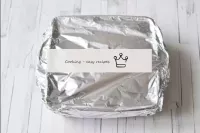 Cover the mould with foil. Put the pork in the ove...