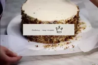 Cover the cake with cream, line and garnish with n...