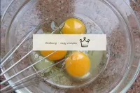 Break the eggs into a bowl, beat them with a whisk...