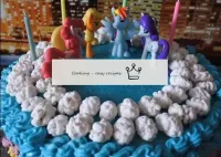 Top the cake with marshmallow clouds and pony figu...