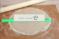 Drizzle the parchment or baking mat with flour, po...