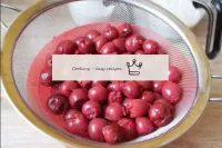 Next, we strain the cherries from the can. It is b...