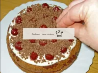 Sprinkle liberally over the top of the cake with g...