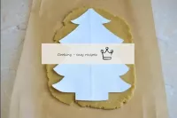 Cut the Christmas tree stencil from a sheet of pap...