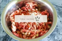 Pour salt, ground paprika into the minced meat. Ad...