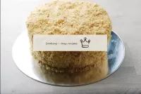 Generously sprinkle the cake with crumbs on all si...