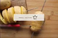 Without pulling out the knife, cut the potatoes al...