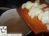 Onions are lowered into boiling broth for 2-3 minu...
