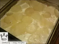 Potatoes with eggs and milk are baked in a preheat...