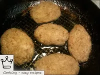 Heat the oil in a pan. Fry the round rissoles in o...