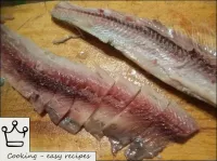Peel the herring by separating the meat from the r...