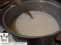 Stir and continue cooking the rice with a low simm...