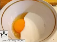 Turn on the oven. Mix raw eggs with sour cream. ...