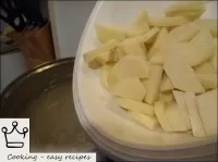 After boiling, potatoes cut into wedges are added....