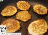 Fry pancakes with apples over a medium heat for ab...