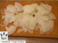 Peel the onions, cut into thin quarters of rings. ...