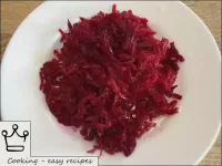 Clean the cooled beets, grate on a coarse grater a...