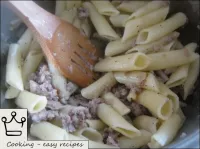 Add minced meat with onions to the pasta. Stir the...