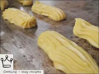 Prepared custard dough is put into paper cornet, b...