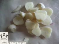 Garlic is peeled, cut into pieces. ...