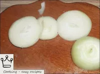 Onions are peeled and cut into rings. ...
