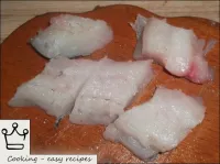 Prepared fillet is cut into portions. ...