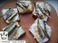 Put 2-3 sprats or a whole sardine on each slice of...