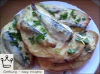 Serve toast with sprats and cheese on the table im...